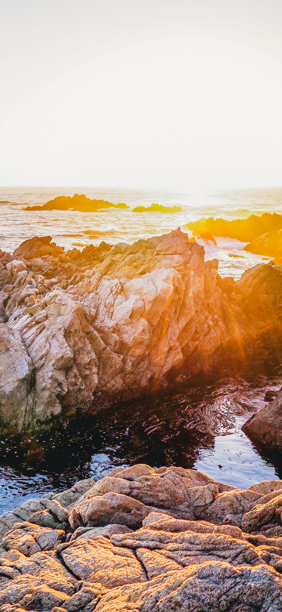 [2436×1125]夕阳 海水 岩石 阳光 苹果手机壁纸图片